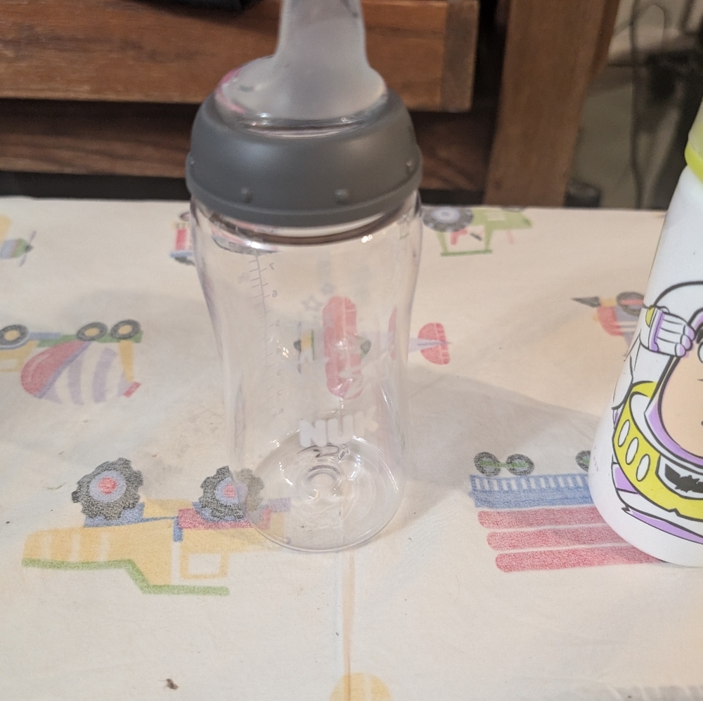 2 nuk bottles and bottle cleaner